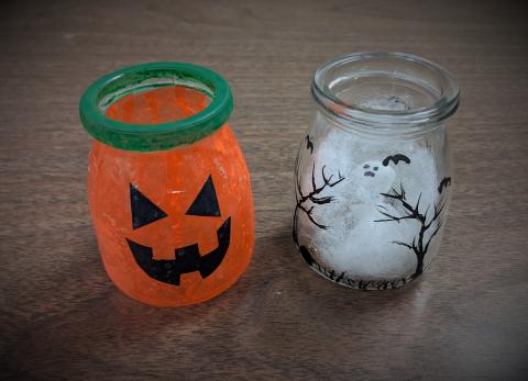 jack o' lantern jar and jar with trees painted on with ghost inside