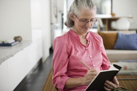 woman writing in book