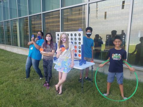 Group of teens playing jumbo Connect 4