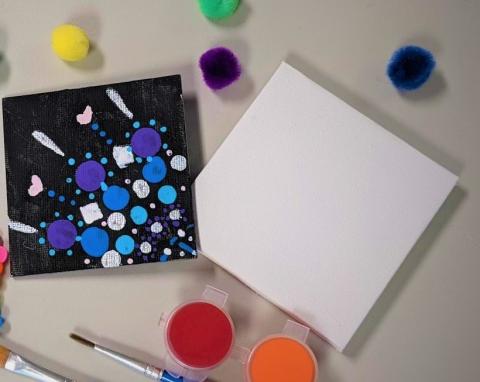 canvas with dot art, blank canvas, random assortment of art supplies