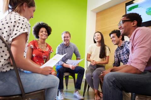 A circle of adults having a discussion.