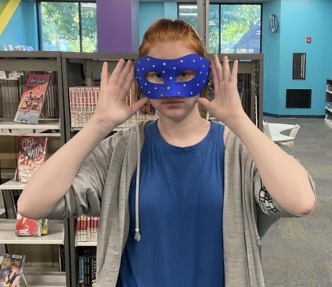 teen wearing a blue mask with gems