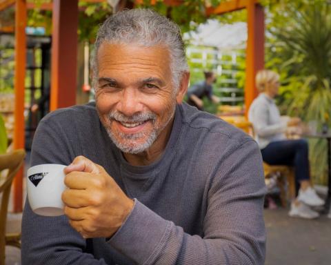 picture of man holding a white cup