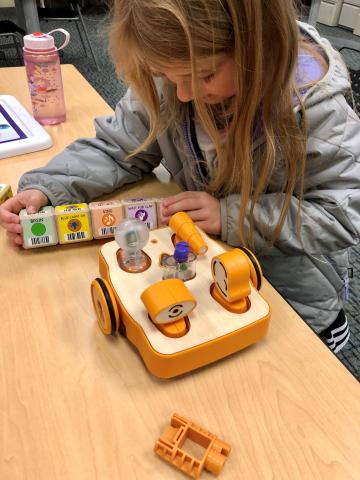 child assembling coding blocks for kibo robot