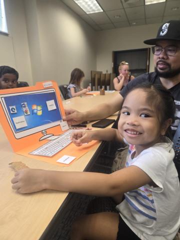 child at manila folder laptop