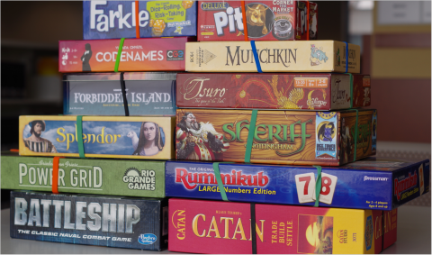 A stack of board games of various titles