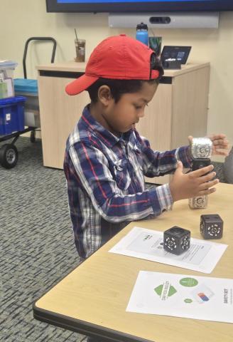 child playing with Cubelets coding blocks