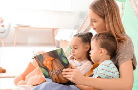 Family of Hispanic descent reading a book together