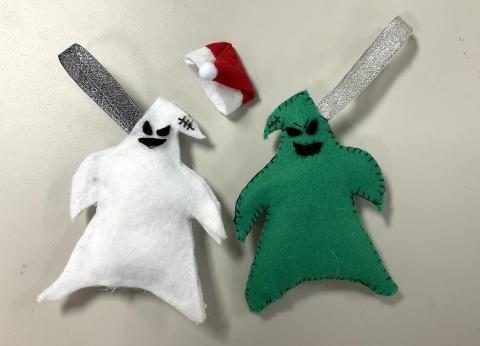 white Oogie Boogie feltie, Santa hat, and green Oogie Boogie feltie