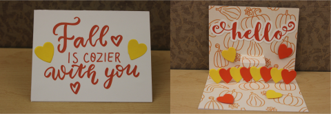 Fall is cozier with you text and hearts on cover. Inside card there are hearts on the pop-up and background plus the word hello. The background also has a pumpkin pattern.