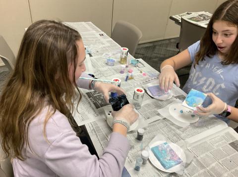 2 teen girls painting pouring on tiny canvases