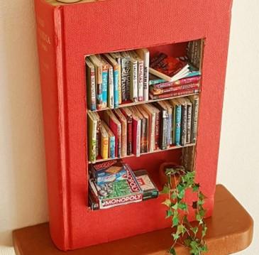 Bookcase made from a hardback book, filled with mini books