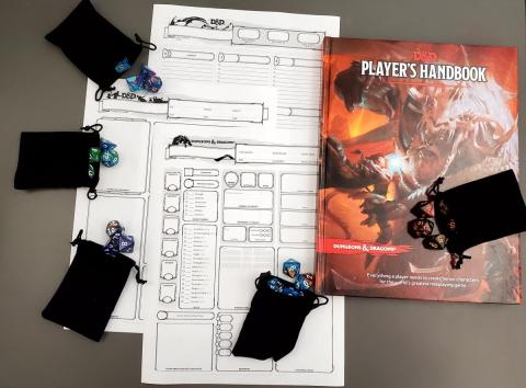 Dungeons and Dragons character sheets, player manual book, and bags of dice