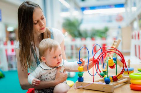 mother and baby playing with toy