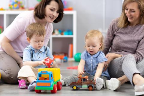 Two women playing with two children