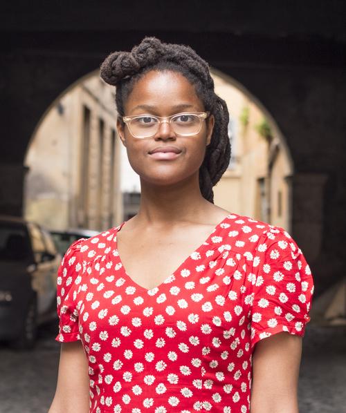 Oge Mora in a red polka dot dress