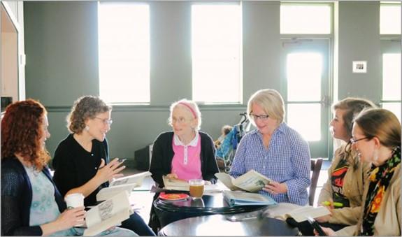 Group of people sitting discussing books