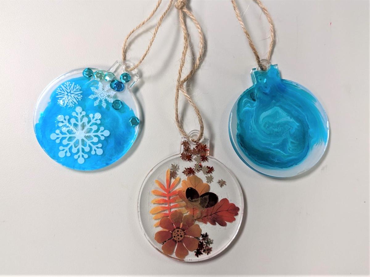 resin ornament with snowflake and blue dye, resin ornament with fall images, and resin ornament with abstract blue dye