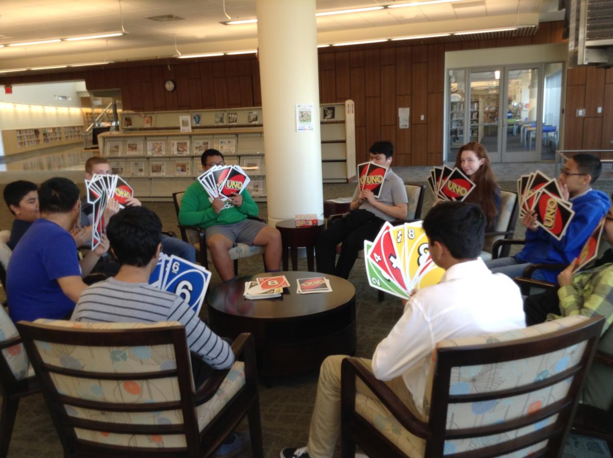 Group of teens playing jumbo UNO