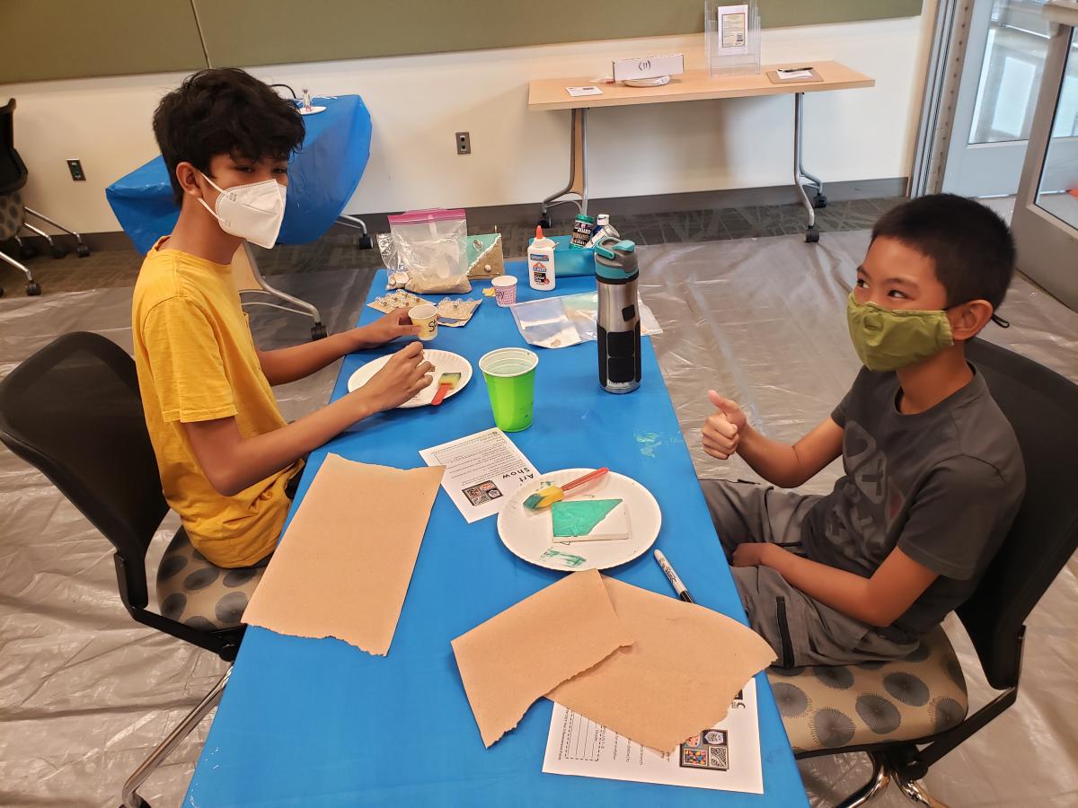 Teens painting on tiny canvas