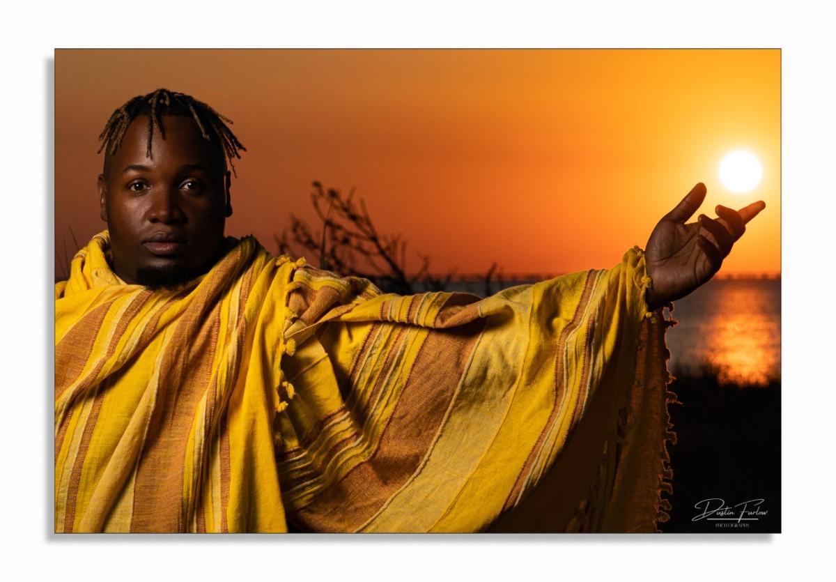 Photograph of a man holding out his arm by Dustin Furlow