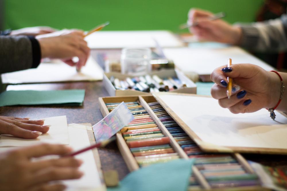 Shows hands working with art materials 