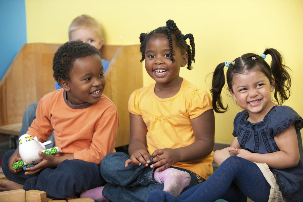 Preschool kids sitting side by side