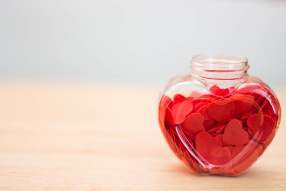 heart shaped bottle filled with red hearts