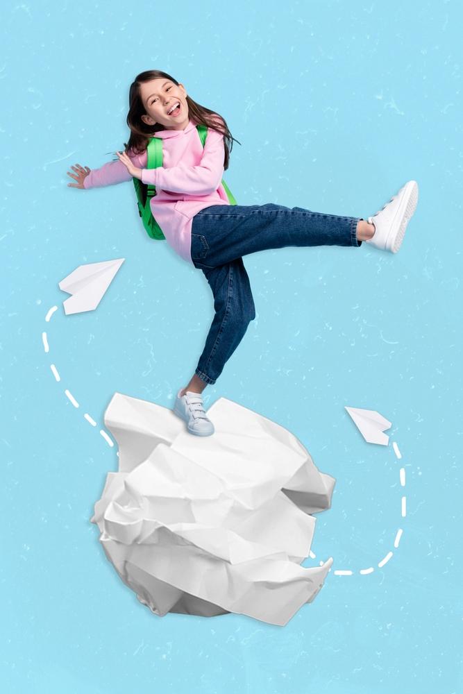 girl kicking a paper ball