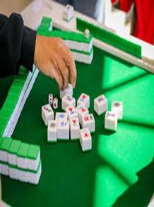 green felt table with white and green mahjong tiles