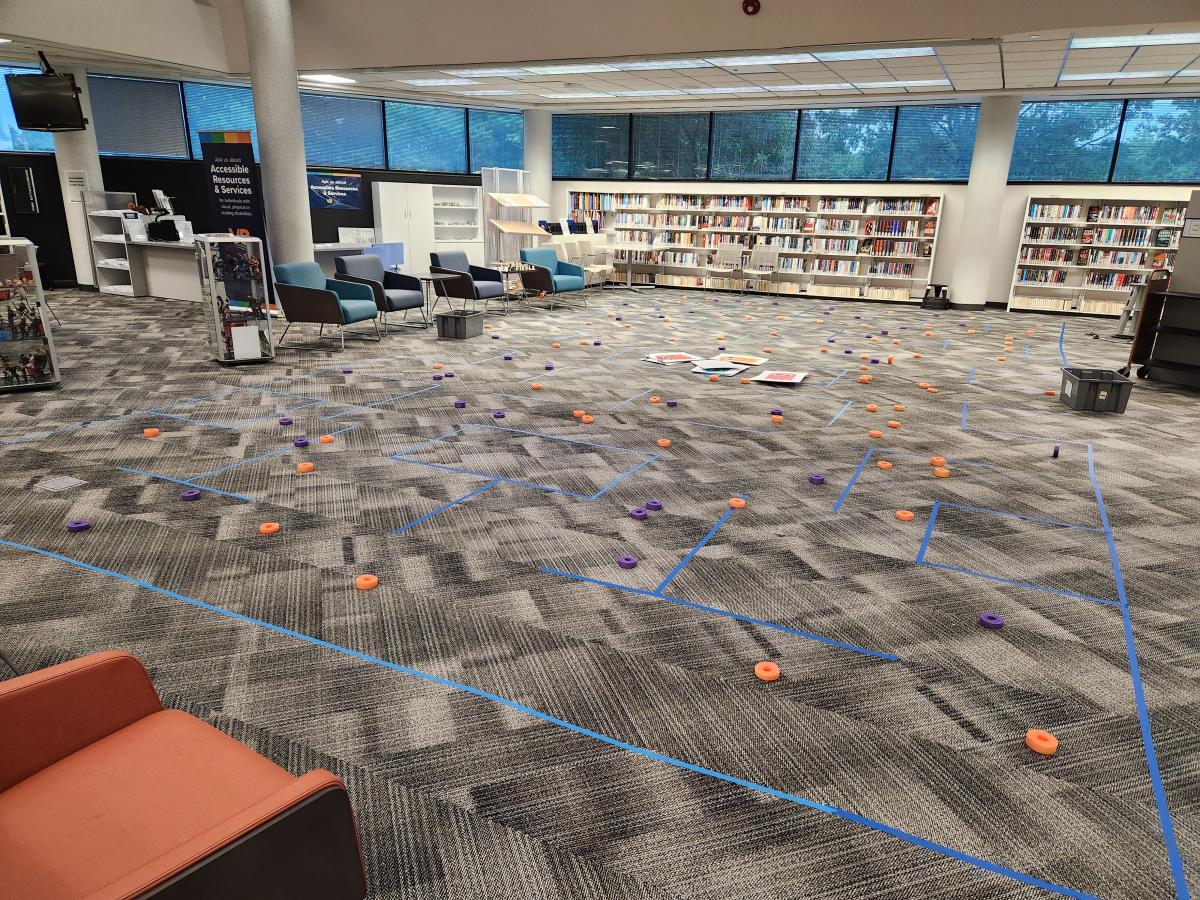 Library floor set-up with blue tape and foam pieces for Life Size Pac-Man