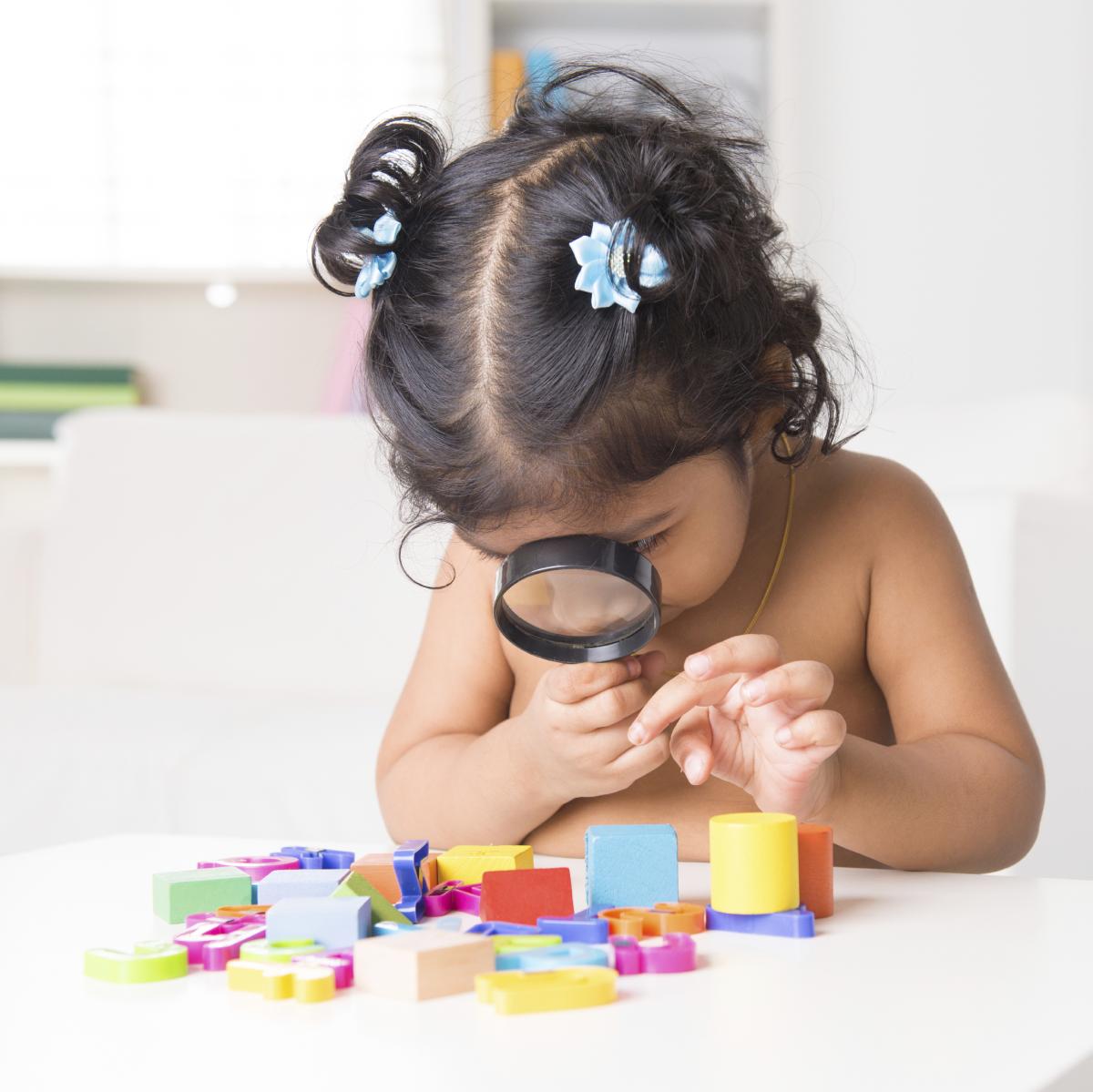 little girl with magnifying glass