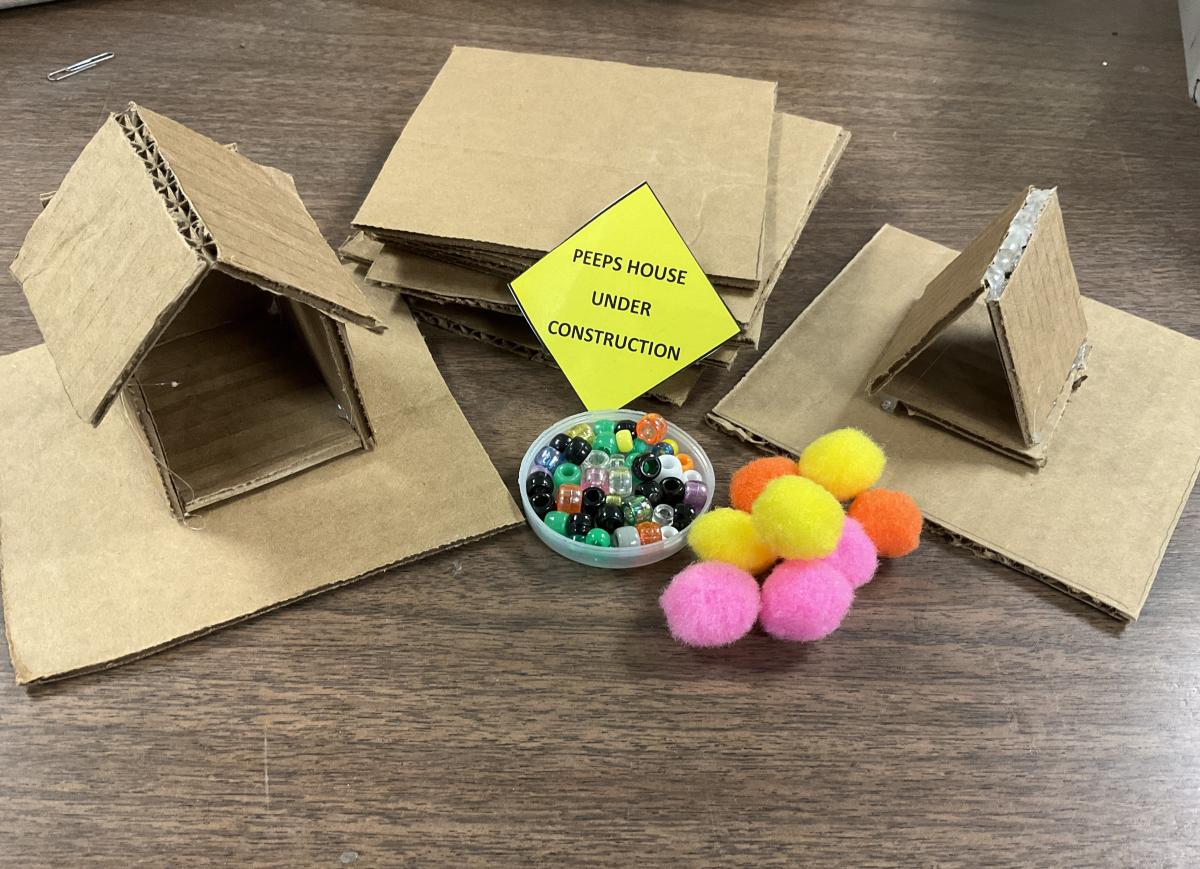 cardboard house, stack of cardboard, construction sign, cardboard tent, pom poms, and beads