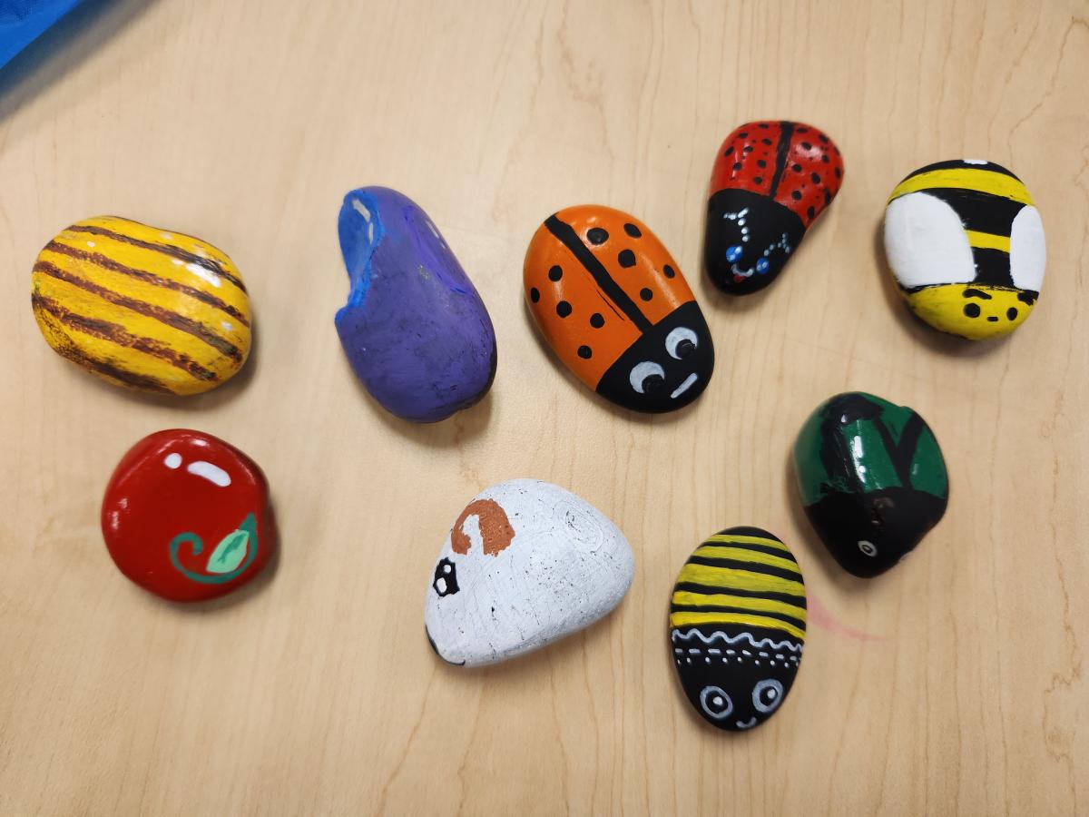 Sample of rocks teens painted in various bugs and food designs.