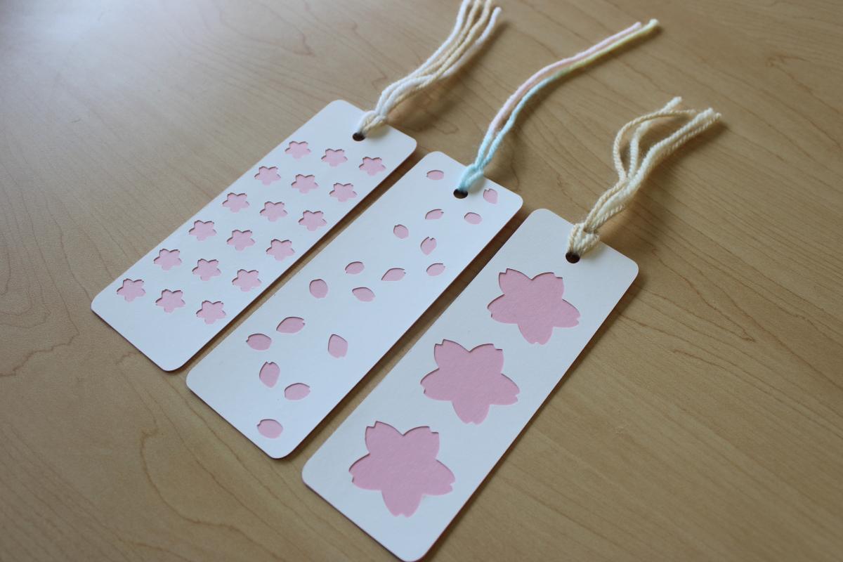 three cherry blossom themed paper bookmarks